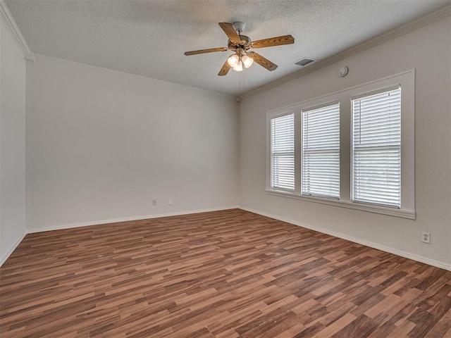 unfurnished room with wood finished floors, a textured ceiling, ornamental molding, ceiling fan, and baseboards