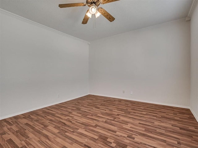 unfurnished room with wood finished floors, ornamental molding, ceiling fan, and baseboards