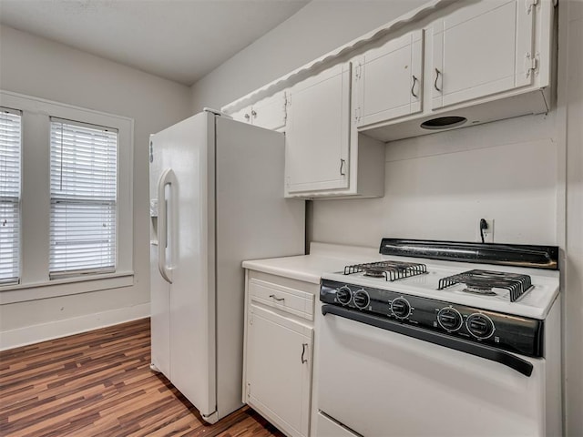kitchen with white appliances, wood finished floors, and white cabinets