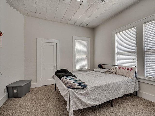 carpeted bedroom with multiple windows