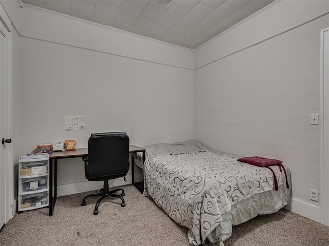 bedroom featuring ornamental molding and light carpet