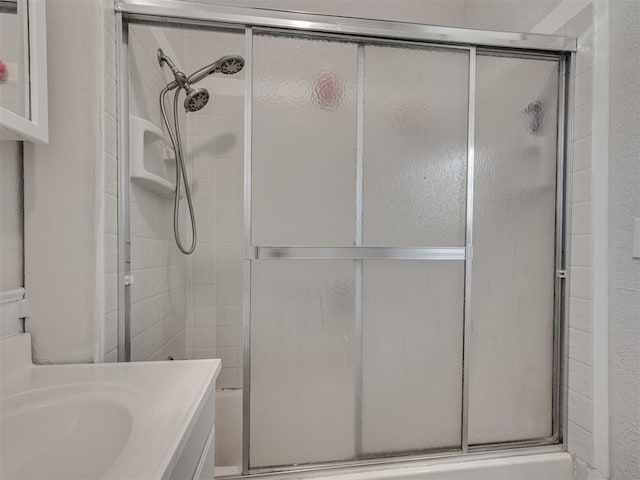 full bathroom with vanity and shower / bath combination with glass door