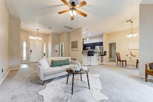 619 Rimrock Rd, Edmond, OK 73034 - living area featuring light colored carpet, baseboards, ceiling fan, and a chandelier