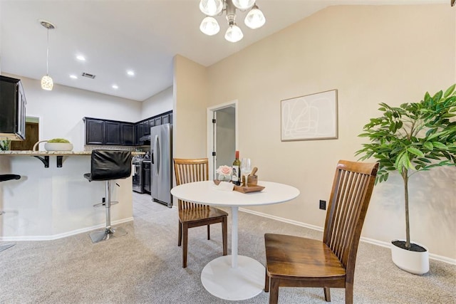 619 Rimrock Rd, Edmond, OK 73034 - dining area with light carpet, baseboards, lofted ceiling, a chandelier, and recessed lighting