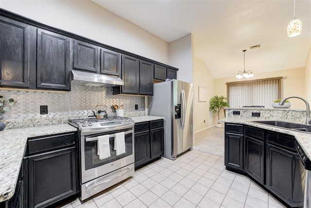 619 Rimrock Rd, Edmond, OK 73034 - kitchen featuring appliances with stainless steel finishes, under cabinet range hood, a sink, lofted ceiling, and decorative backsplash