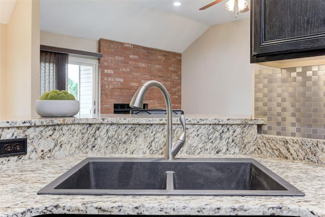 619 Rimrock Rd, Edmond, OK 73034 - kitchen with a sink, ceiling fan, vaulted ceiling, decorative backsplash, and dark brown cabinetry