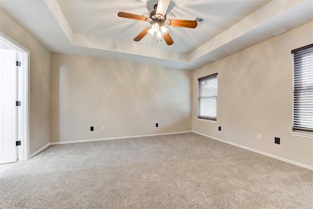 619 Rimrock Rd, Edmond, OK 73034 - empty room featuring carpet flooring, a tray ceiling, a ceiling fan, and baseboards