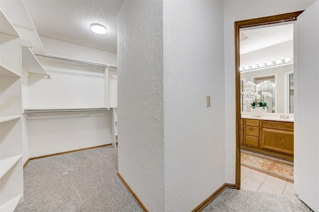 619 Rimrock Rd, Edmond, OK 73034 - spacious closet with carpet and tile patterned floors