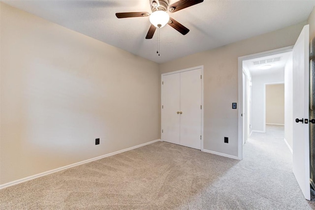 619 Rimrock Rd, Edmond, OK 73034 - unfurnished bedroom featuring carpet flooring, baseboards, a ceiling fan, and a closet