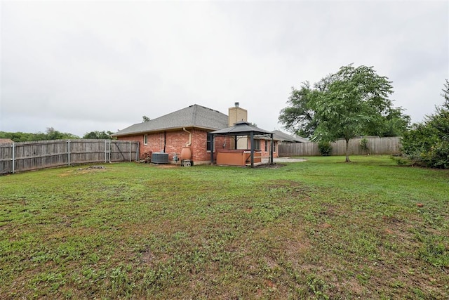 619 Rimrock Rd, Edmond, OK 73034 - view of yard featuring a gazebo, central AC, and a hot tub