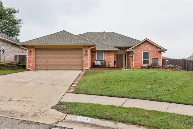 619 Rimrock Rd, Edmond, OK 73034 - view of front facade featuring an attached garage, driveway, brick siding, and a shingled roof