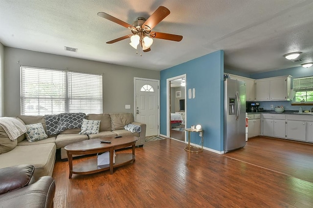 109 E Hayes St, Norman, OK 73069 - living room featuring ceiling fan, dark wood-style flooring, a textured ceiling, and baseboards