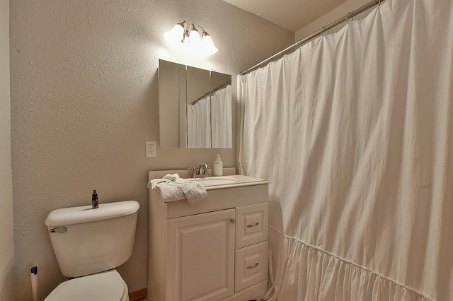 109 E Hayes St, Norman, OK 73069 - bathroom featuring a textured wall, toilet, and vanity