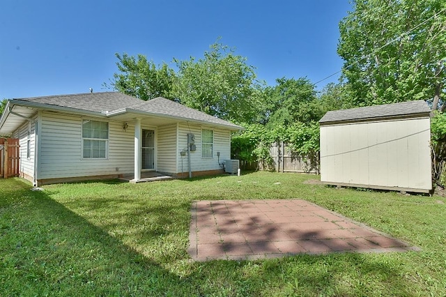 109 E Hayes St, Norman, OK 73069 - back of property with a storage shed, an outbuilding, a patio, and a shingled roof