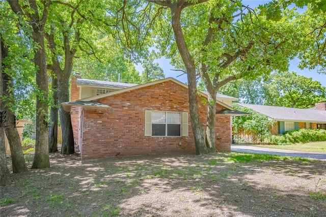5016 NW 26th St, Oklahoma City, OK 73127 - view of side of home with a chimney and brick siding