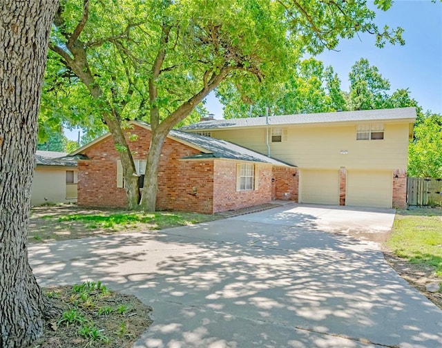 5016 NW 26th St, Oklahoma City, OK 73127 - view of front of home featuring brick siding, driveway, and an attached garage