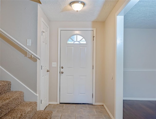 5016 NW 26th St, Oklahoma City, OK 73127 - entryway featuring a textured ceiling, stairs, and baseboards