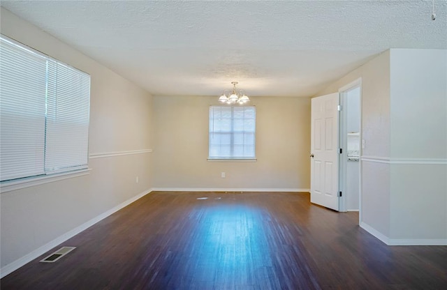 5016 NW 26th St, Oklahoma City, OK 73127 - unfurnished room with wood finished floors, a chandelier, baseboards, and a textured ceiling