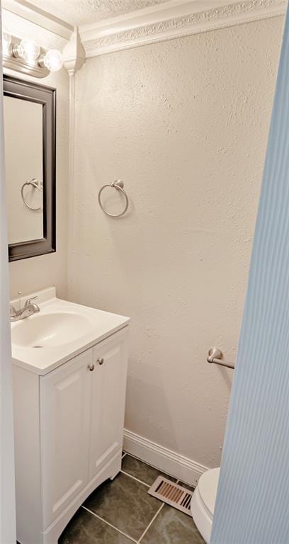 5016 NW 26th St, Oklahoma City, OK 73127 - half bathroom featuring tile patterned flooring, vanity, toilet, and baseboards