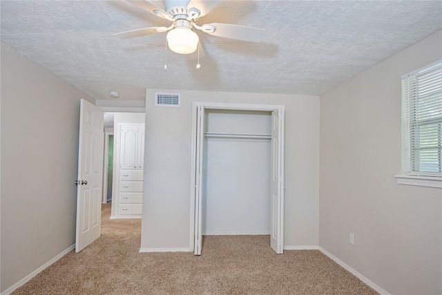 5016 NW 26th St, Oklahoma City, OK 73127 - unfurnished bedroom with light carpet, a textured ceiling, a closet, a ceiling fan, and baseboards