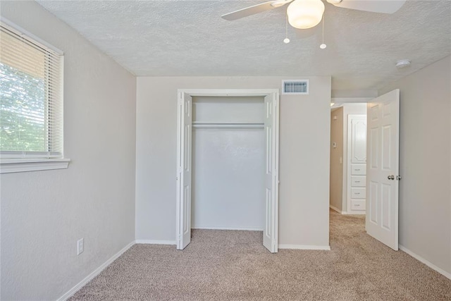 5016 NW 26th St, Oklahoma City, OK 73127 - unfurnished bedroom with a textured ceiling, light carpet, a closet, and baseboards