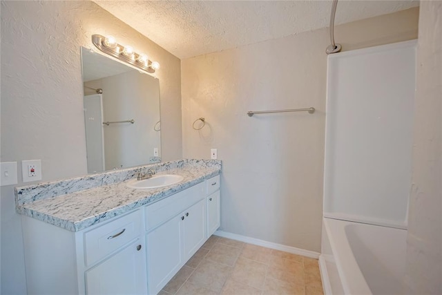 5016 NW 26th St, Oklahoma City, OK 73127 - full bathroom with a textured ceiling, vanity, tile patterned floors, and washtub / shower combination