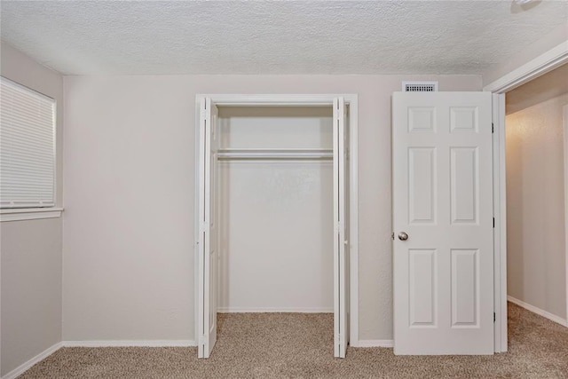 5016 NW 26th St, Oklahoma City, OK 73127 - unfurnished bedroom featuring carpet flooring, a closet, and a textured ceiling