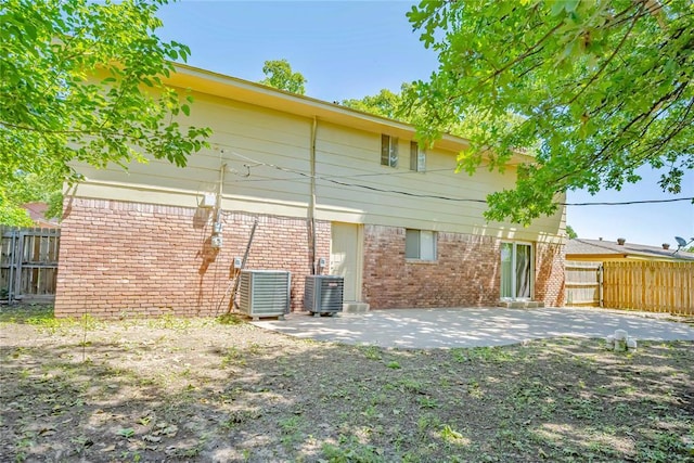 5016 NW 26th St, Oklahoma City, OK 73127 - back of house with fence, brick siding, a patio, and central AC unit