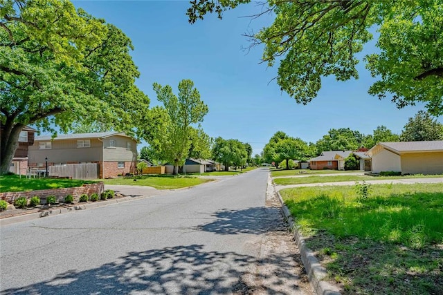 5016 NW 26th St, Oklahoma City, OK 73127 - view of asphalt street with curbs and a residential view