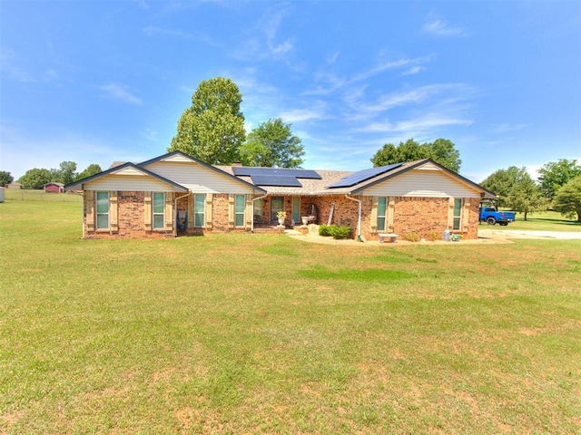 764 S Sara Rd, Tuttle, OK 73089 - ranch-style home featuring solar panels, a front lawn, and brick siding
