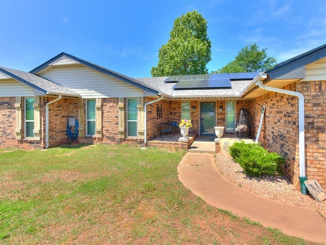 764 S Sara Rd, Tuttle, OK 73089 - single story home with a front yard, roof mounted solar panels, brick siding, and roof with shingles