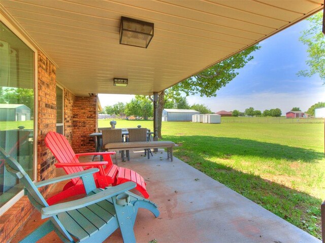 764 S Sara Rd, Tuttle, OK 73089 - view of patio / terrace with a storage unit and an outdoor structure