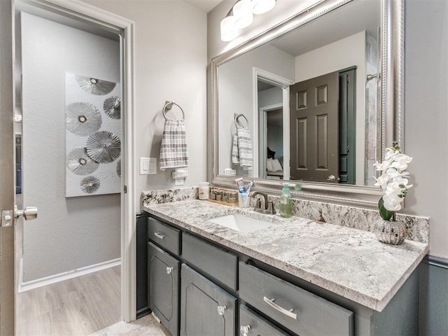 764 S Sara Rd, Tuttle, OK 73089 - bathroom featuring vanity, wood finished floors, and baseboards