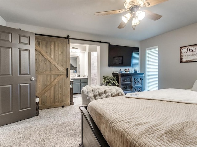 764 S Sara Rd, Tuttle, OK 73089 - bedroom featuring a barn door, light carpet, a ceiling fan, and connected bathroom