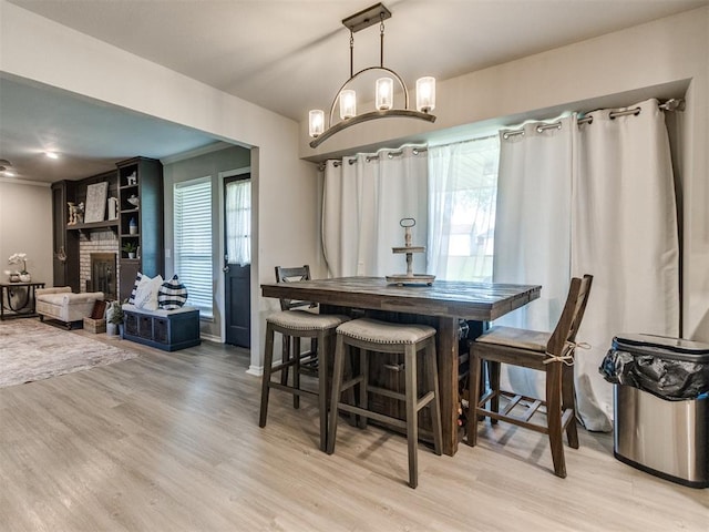 764 S Sara Rd, Tuttle, OK 73089 - dining area with light wood-style flooring and a brick fireplace