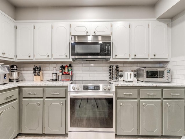 764 S Sara Rd, Tuttle, OK 73089 - kitchen featuring stainless steel appliances, decorative backsplash, white cabinets, and gray cabinets