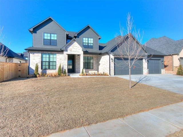4405 Las Colinas Ln, Norman, OK 73072 - view of front facade featuring concrete driveway, an attached garage, and stone siding