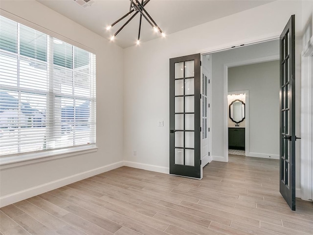 4405 Las Colinas Ln, Norman, OK 73072 - spare room featuring french doors, healthy amount of natural light, and baseboards