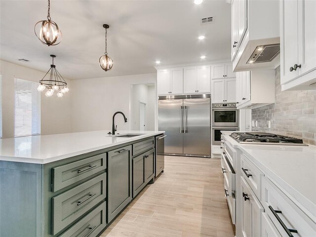 4405 Las Colinas Ln, Norman, OK 73072 - kitchen featuring stainless steel appliances, a sink, white cabinetry, backsplash, and recessed lighting