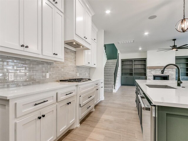 4405 Las Colinas Ln, Norman, OK 73072 - kitchen featuring a sink, appliances with stainless steel finishes, white cabinets, decorative backsplash, and recessed lighting