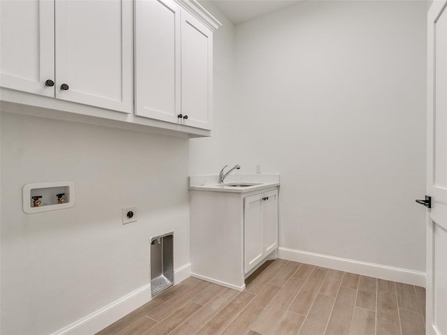4405 Las Colinas Ln, Norman, OK 73072 - washroom with cabinet space, light wood-type flooring, baseboards, washer hookup, and electric dryer hookup