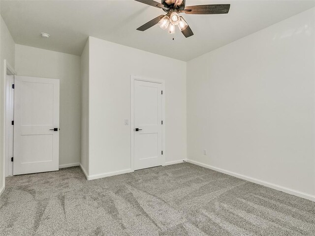 4405 Las Colinas Ln, Norman, OK 73072 - unfurnished bedroom with carpet flooring, baseboards, and a ceiling fan