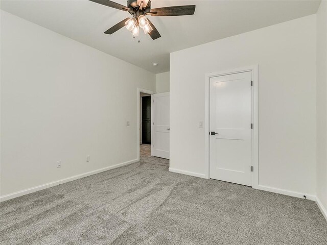 4405 Las Colinas Ln, Norman, OK 73072 - unfurnished bedroom featuring carpet flooring, baseboards, and ceiling fan