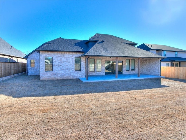 4405 Las Colinas Ln, Norman, OK 73072 - back of house with a patio area, roof with shingles, and brick siding