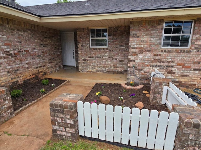 6805 Saint Marys Cir, Oklahoma City, OK 73132 - entrance to property featuring a shingled roof, fence, and brick siding