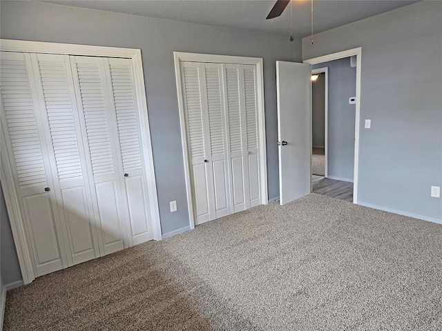 6805 Saint Marys Cir, Oklahoma City, OK 73132 - unfurnished bedroom featuring multiple closets, carpet flooring, baseboards, and a ceiling fan