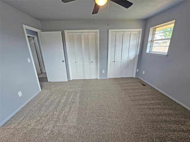6805 Saint Marys Cir, Oklahoma City, OK 73132 - unfurnished bedroom featuring multiple closets, carpet flooring, baseboards, and a ceiling fan