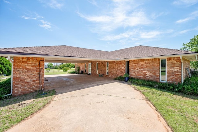 410 NW Taylor Ave, Piedmont, OK 73078 - ranch-style house featuring brick siding, driveway, a carport, a shingled roof, and a front lawn