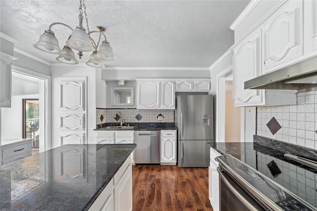 410 NW Taylor Ave, Piedmont, OK 73078 - kitchen featuring appliances with stainless steel finishes, a chandelier, a sink, white cabinetry, and pendant lighting