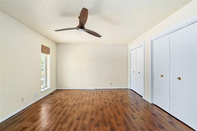 410 NW Taylor Ave, Piedmont, OK 73078 - unfurnished bedroom with multiple closets, dark wood finished floors, baseboards, and a ceiling fan